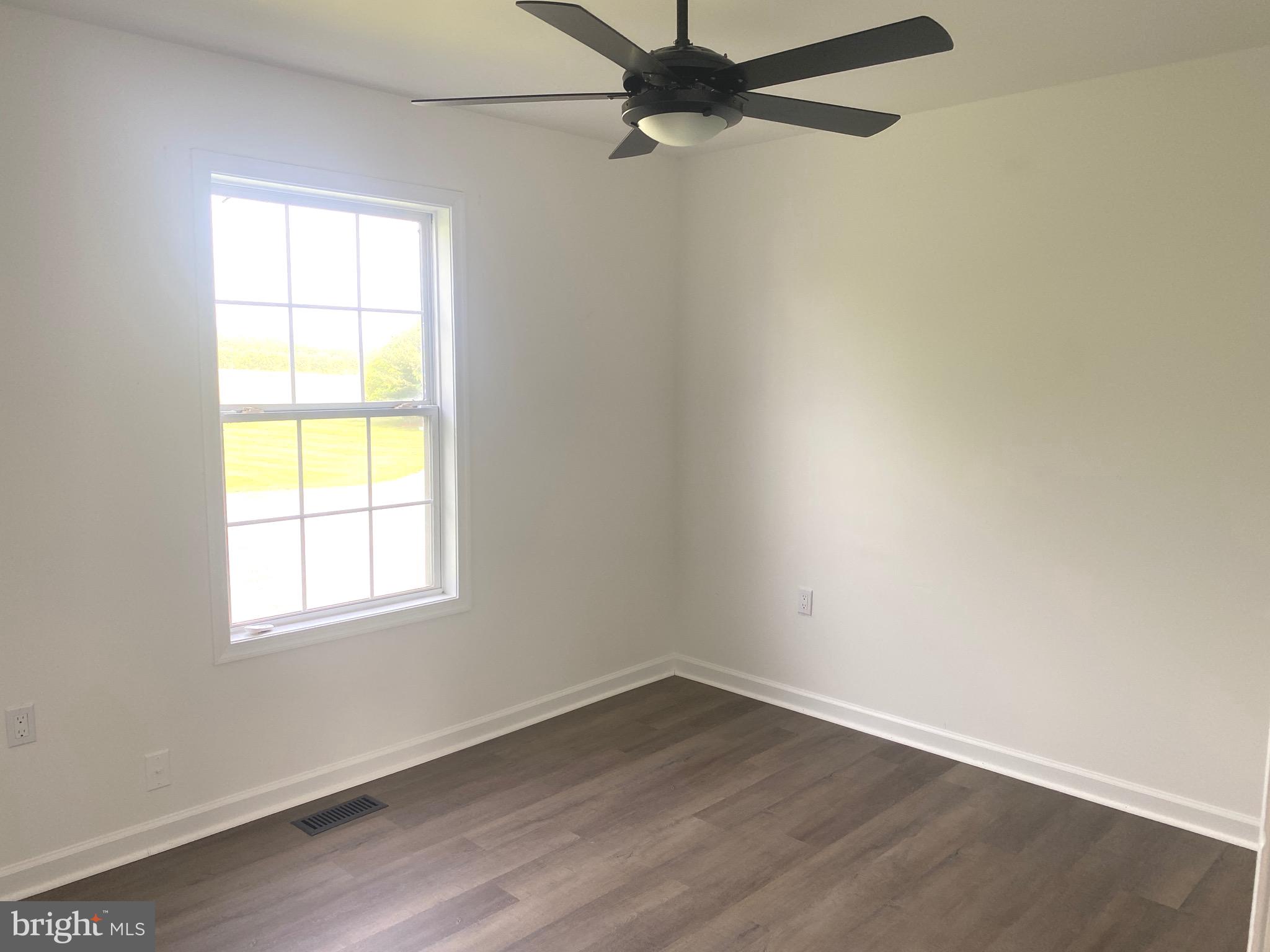 172 Jack Rabbit Lane Ranson, WV 25438 - Photo 18 of 34 an empty room with wooden floor and windows