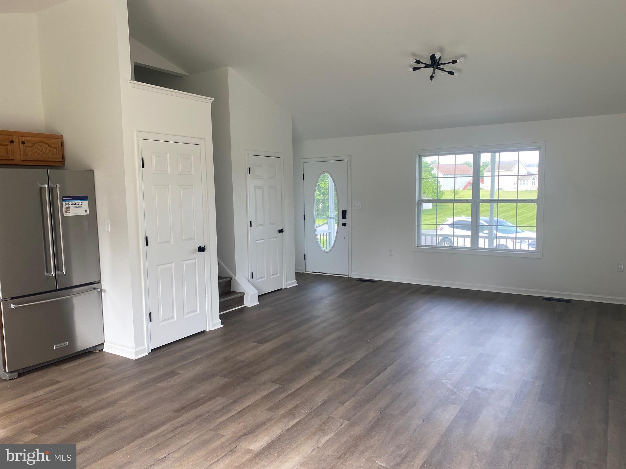 172 Jack Rabbit Lane Ranson, WV 25438 - Photo 10 of 34 an empty room with wooden floor fireplace and windows