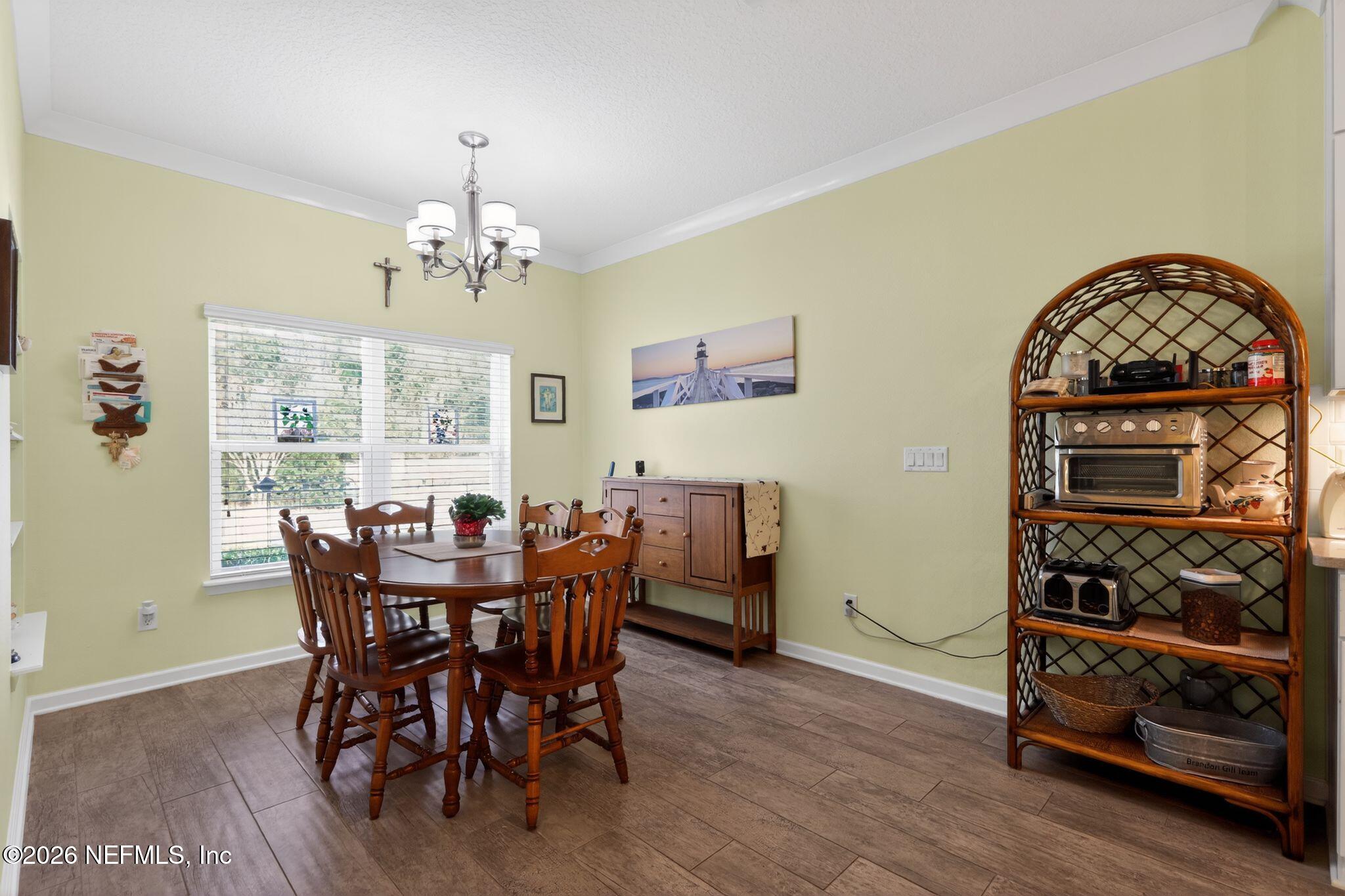 96017 Breezeway Court Yulee, FL 32097 - Photo 11 of 30 a view of a dining room with furniture and wooden floor