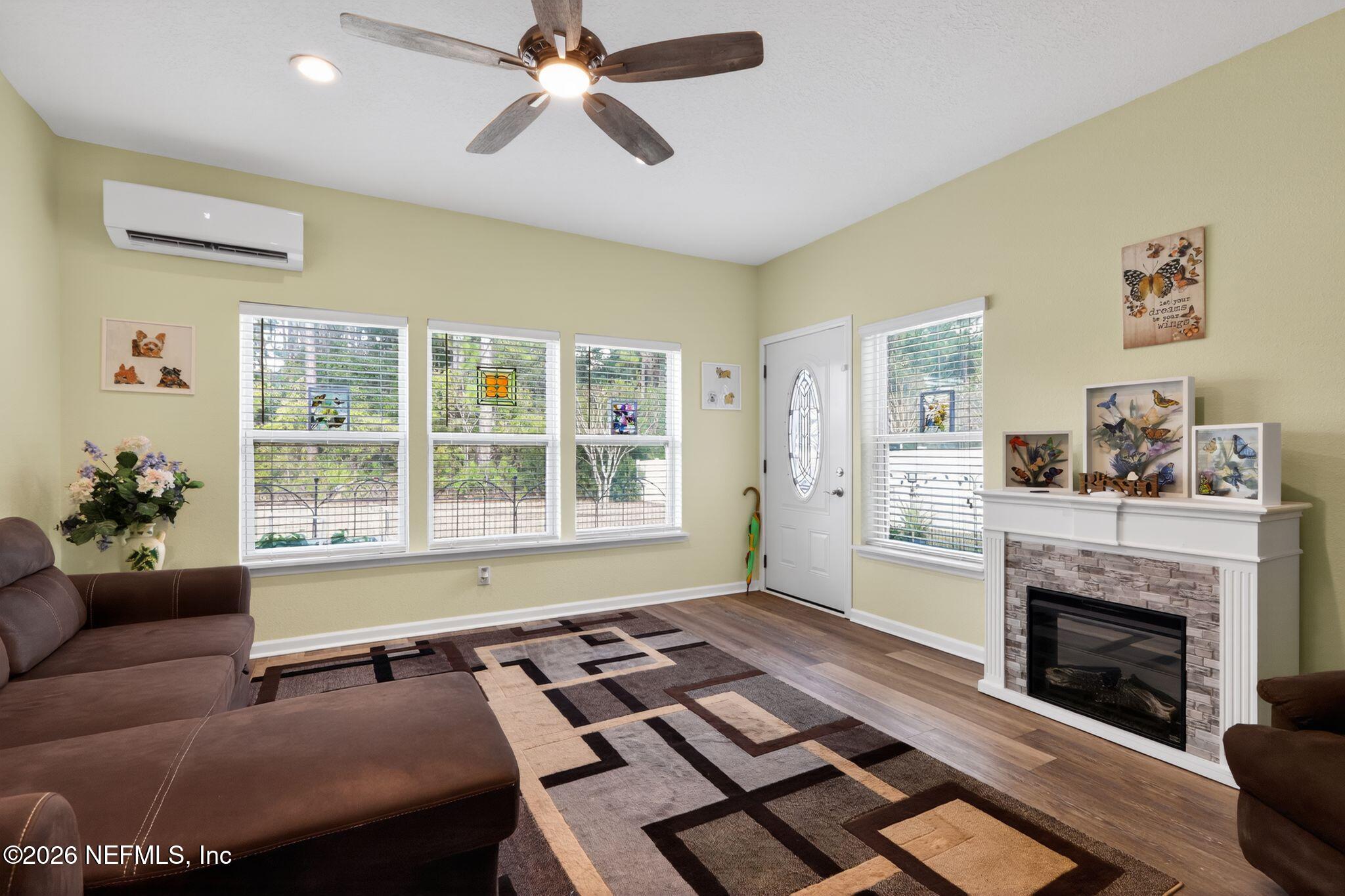96017 Breezeway Court Yulee, FL 32097 - Photo 15 of 30 a living room with furniture and a fireplace