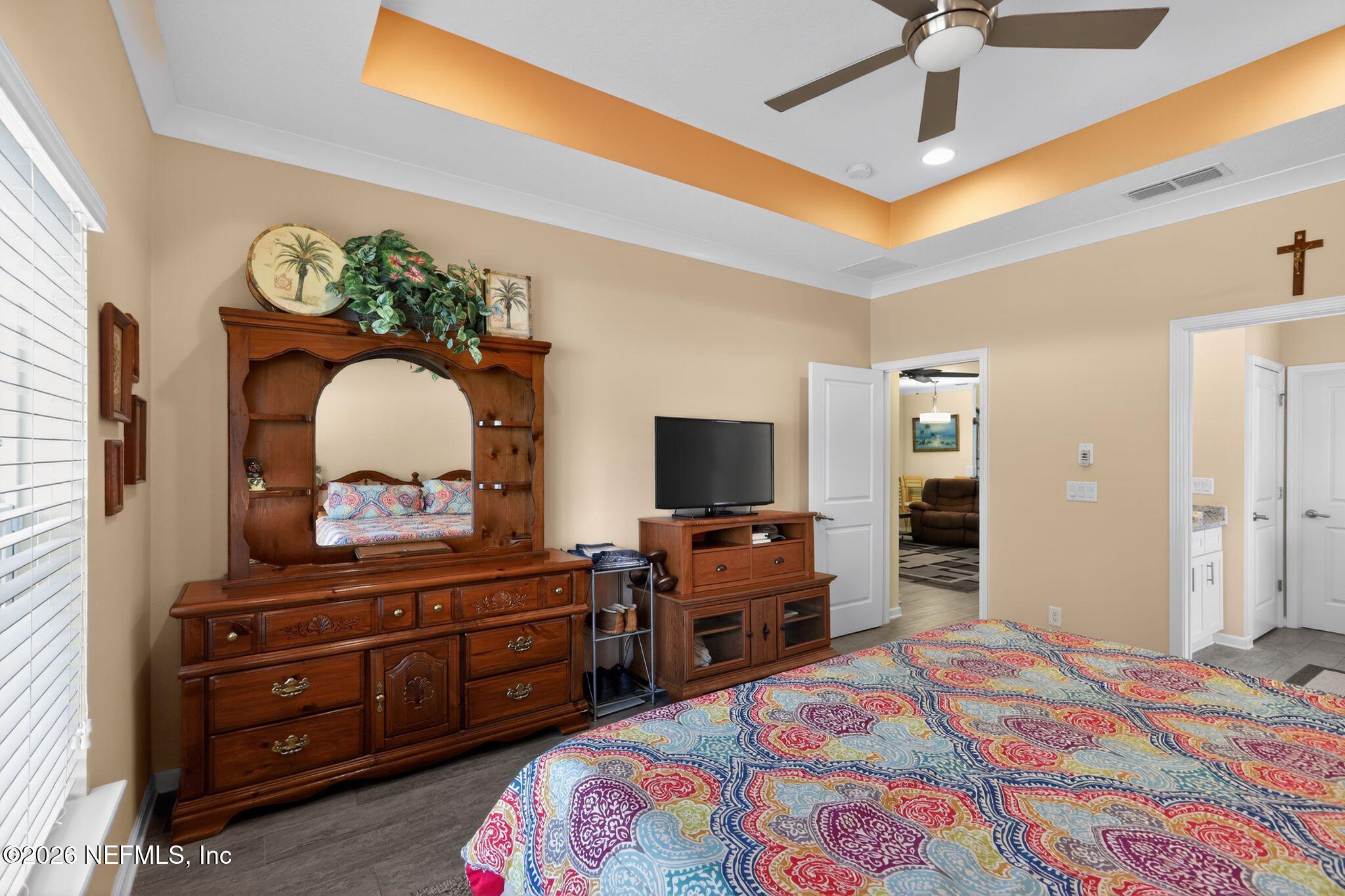 96017 Breezeway Court Yulee, FL 32097 - Photo 17 of 30 a bedroom with a bed and a dresser in it