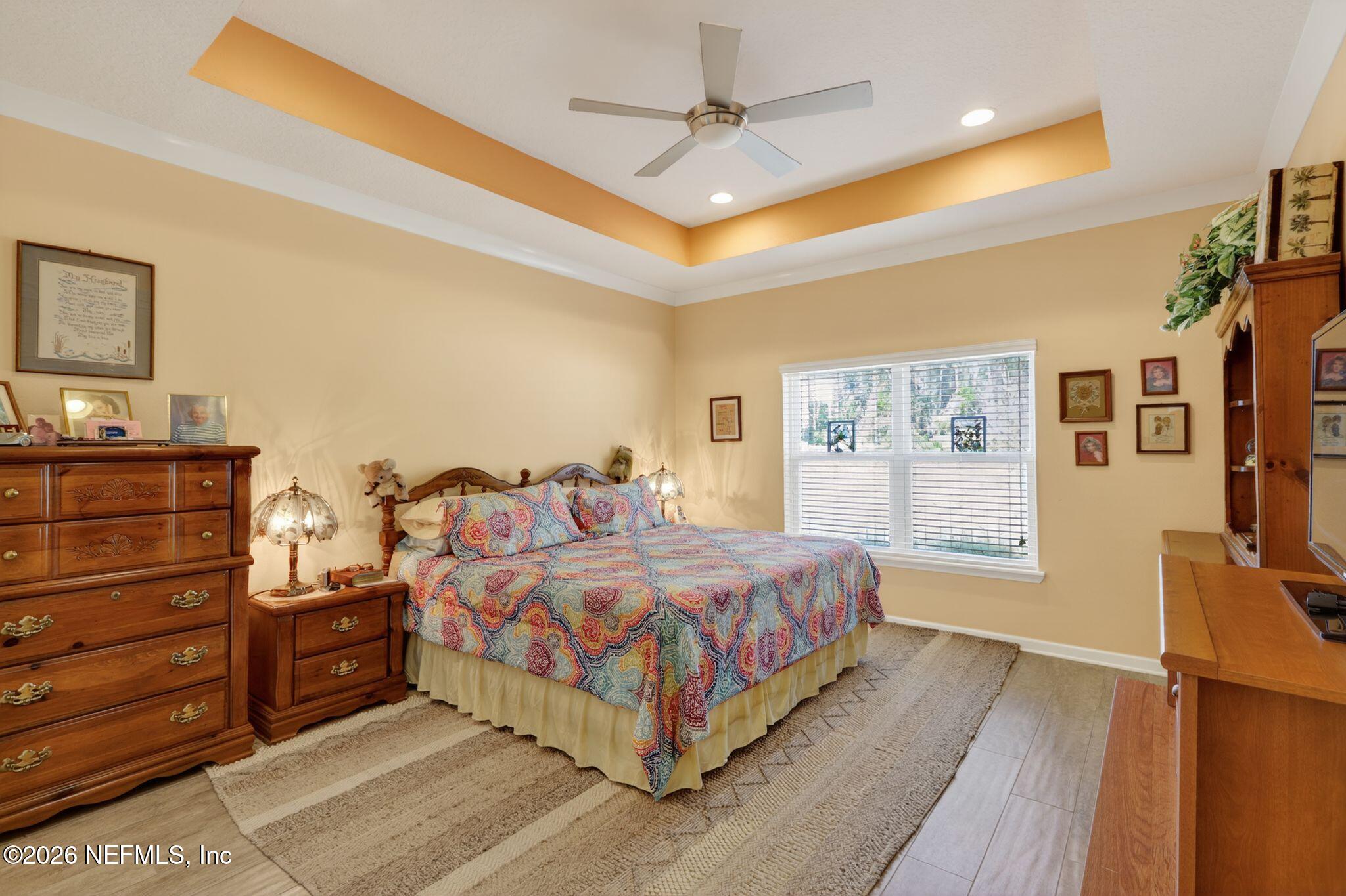 96017 Breezeway Court Yulee, FL 32097 - Photo 18 of 30 a bedroom with a bed and wooden floor