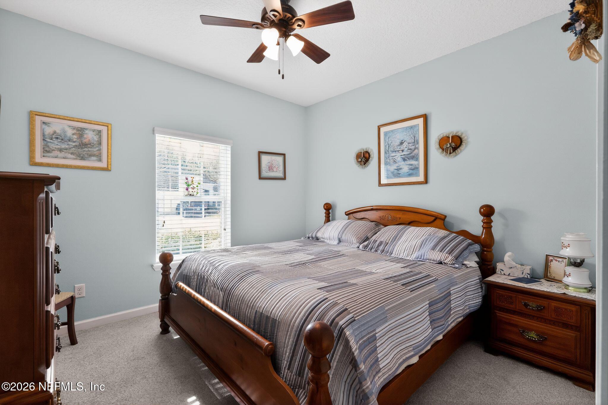 96017 Breezeway Court Yulee, FL 32097 - Photo 23 of 30 a bedroom with bed and window