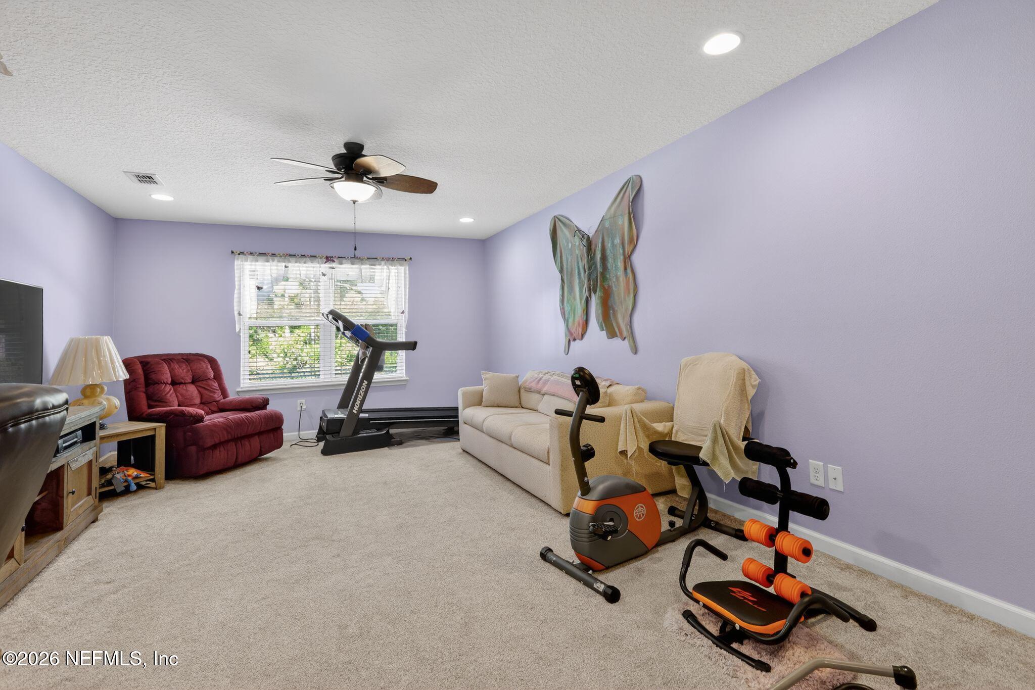 96017 Breezeway Court Yulee, FL 32097 - Photo 25 of 30 a living room with furniture and a window