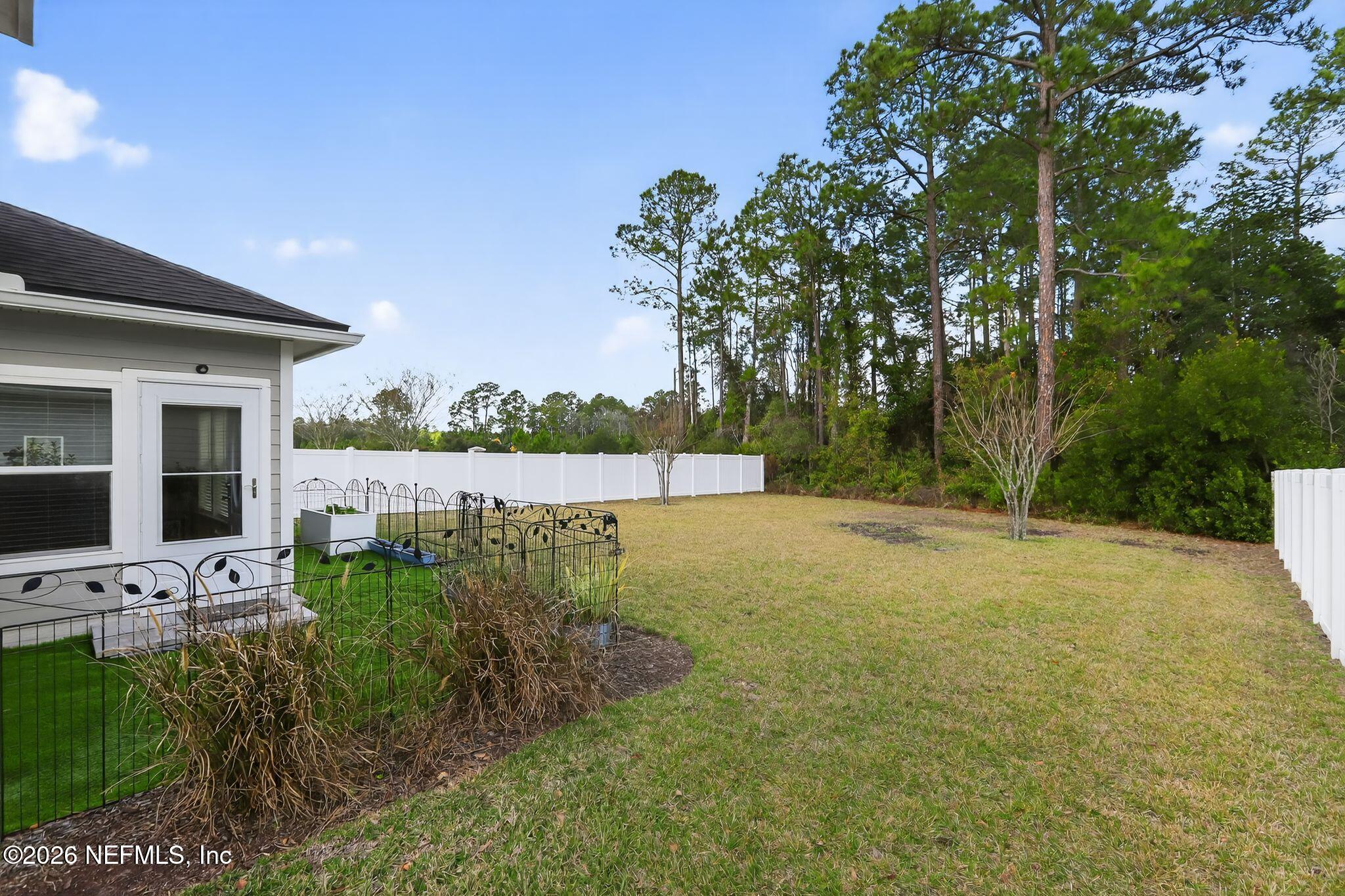 96017 Breezeway Court Yulee, FL 32097 - Photo 29 of 30 a view of a backyard with garden