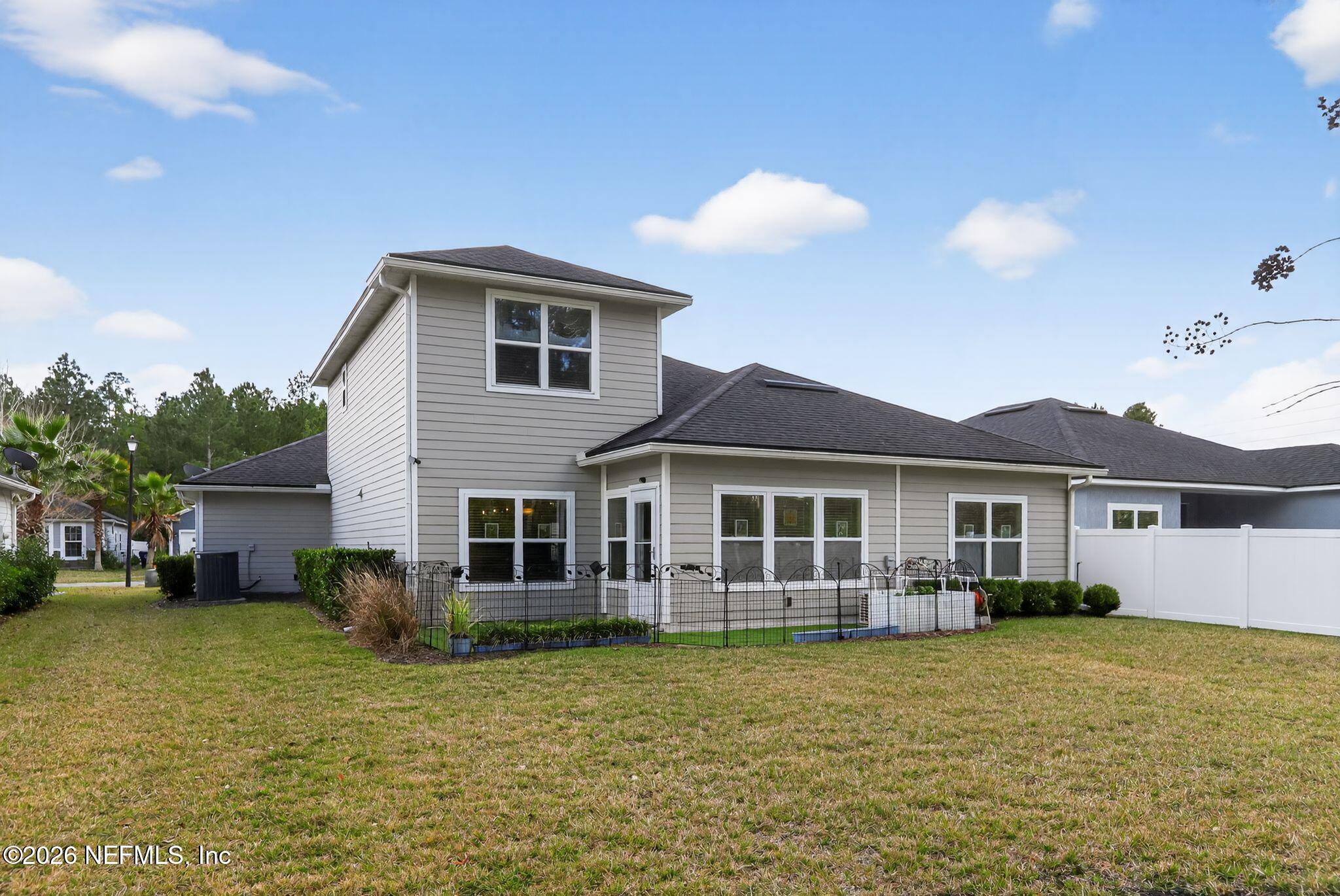96017 Breezeway Court Yulee, FL 32097 - Photo 30 of 30 a front view of a house with a garden