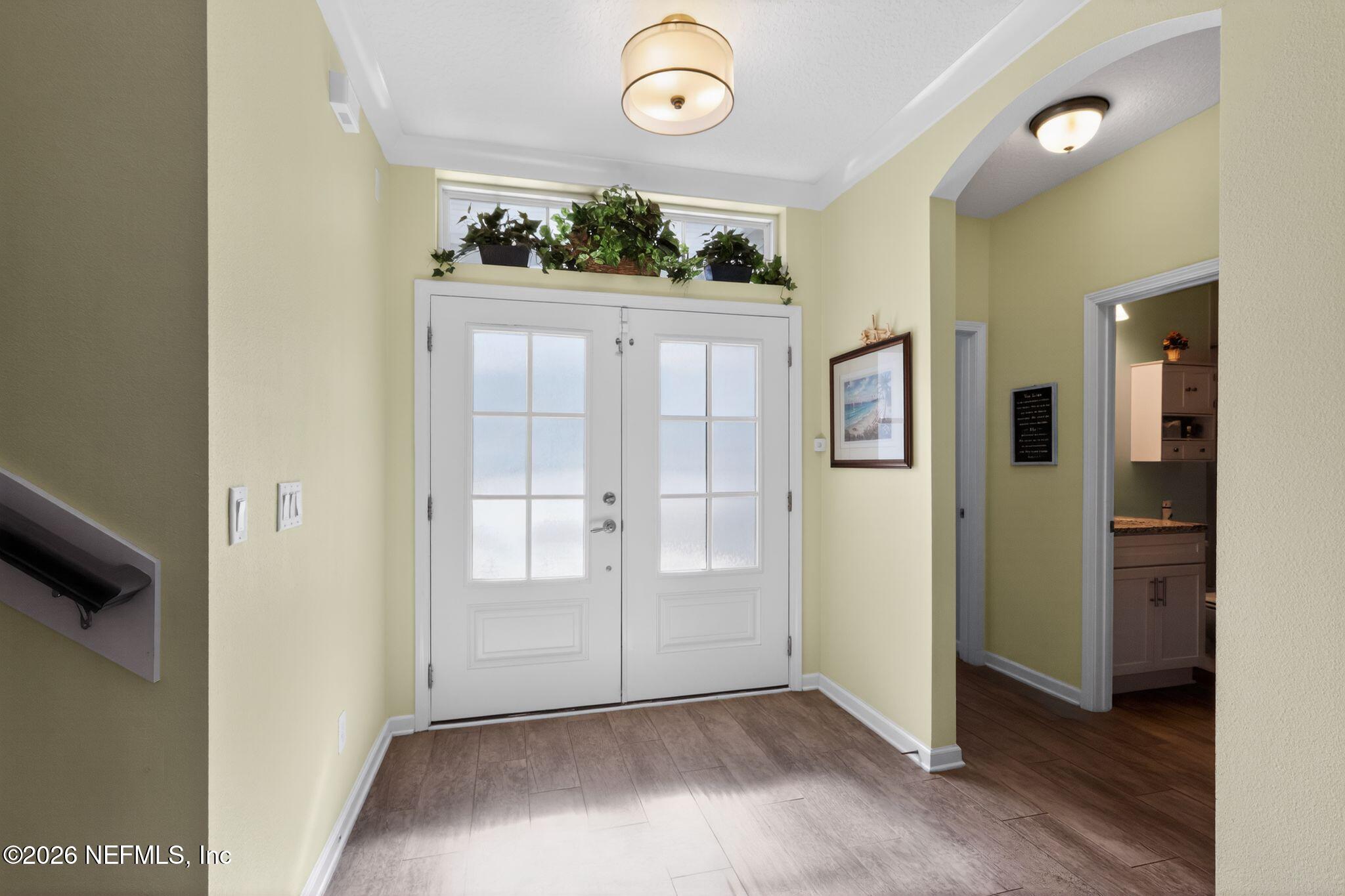 96017 Breezeway Court Yulee, FL 32097 - Photo 4 of 30 an entryway with a dining table and chairs