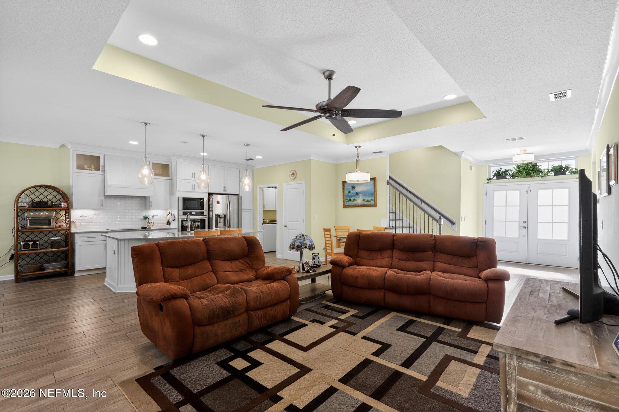 96017 Breezeway Court Yulee, FL 32097 - Photo 6 of 30 a living room with furniture and a view of kitchen