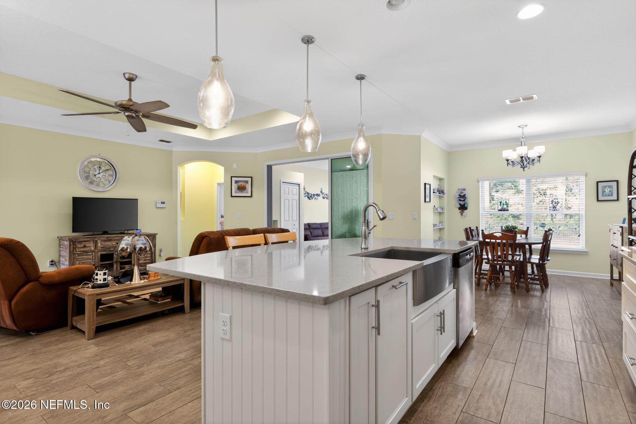 96017 Breezeway Court Yulee, FL 32097 - Photo 9 of 30 a large kitchen with a counter space a sink appliances and a living room view