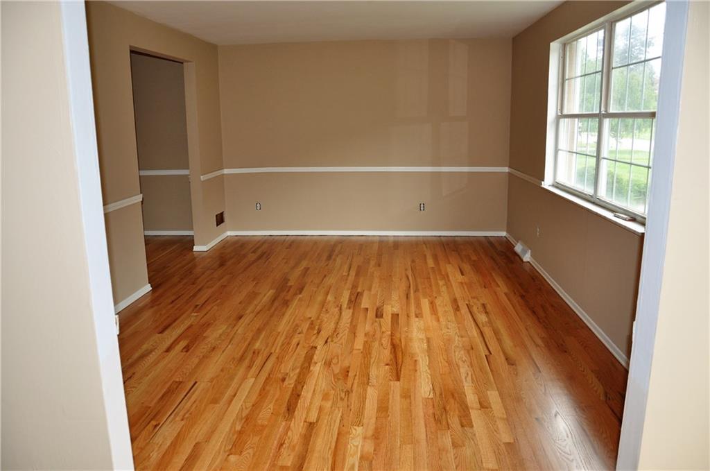 Living room, hardwood floors have been refinished and freshly painted wall. Living room measures 18' x 11'