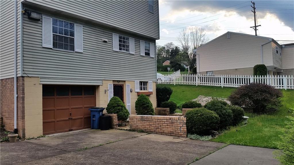 120 Rangley Drive Pittsburgh, PA 15209 - Photo 15 of 18 Private patio with white picket fence. Garage and parking area.