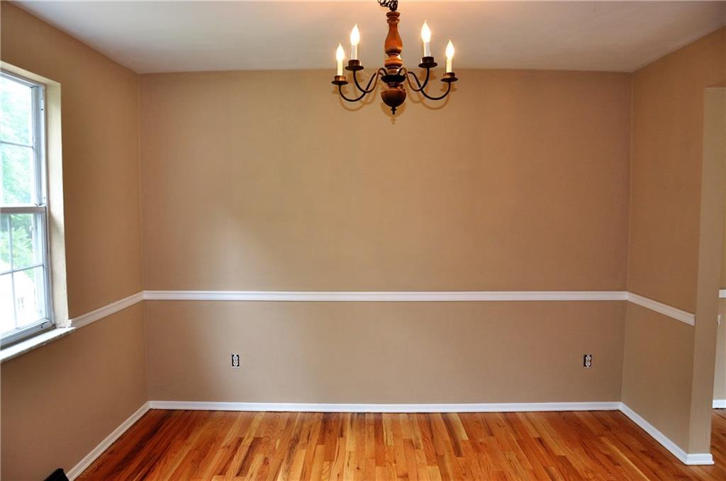Dining room has refinished hardwood floors and fresh paint. Measures 11'x11 and opens to the kitchen.
