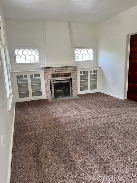 431 Chestnut Avenue Redlands, CA 92373 - Photo 3 of 23 a view of an empty room with a fireplace and a window