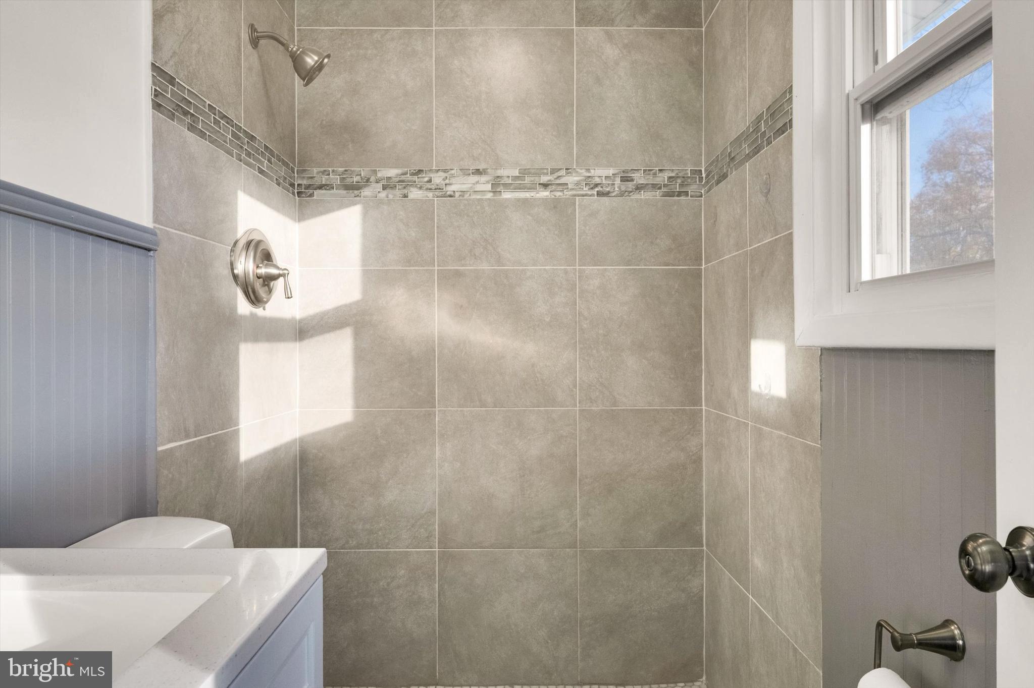 4224 Kinmount Road Lanham, MD 20706 - Photo 21 of 45 a bathroom with a sink and shower