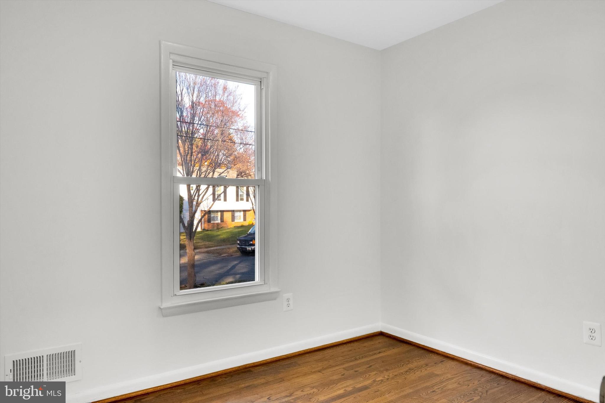 4224 Kinmount Road Lanham, MD 20706 - Photo 25 of 45 a view of empty room with wooden floor and fan