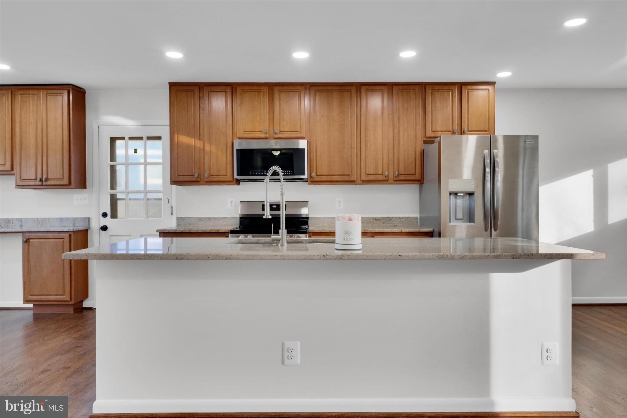4224 Kinmount Road Lanham, MD 20706 - Photo 7 of 45 a kitchen with stainless steel appliances wooden cabinets and a counter top space