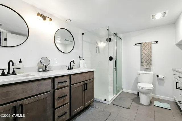 a spacious bathroom with a toilet sink and mirror