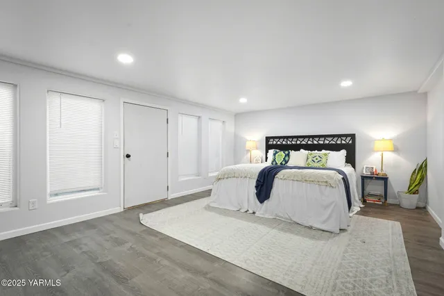 a bedroom with a bed and a lamp