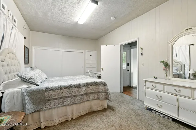 a bedroom with a bed and a dresser