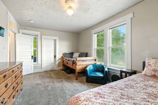 a bedroom with a bed and a large window