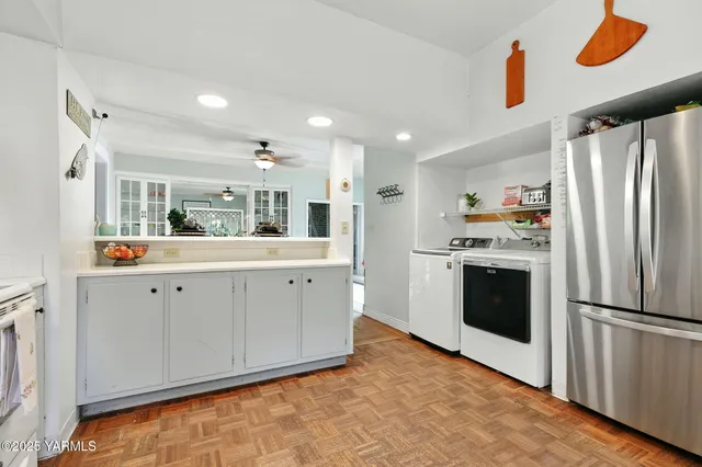 a kitchen with white cabinets and white appliances