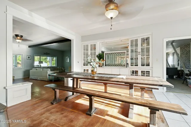 a living room with fireplace furniture and a table