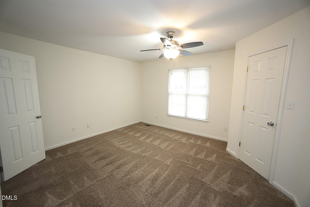 6514 Hearthstone Drive Raleigh, NC 27615 - Photo 11 of 16 an empty room with windows and fan