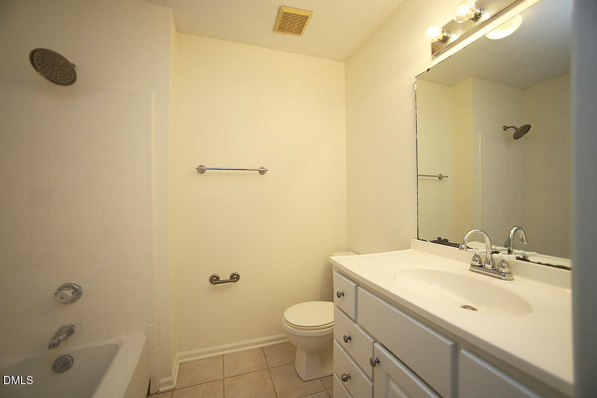 6514 Hearthstone Drive Raleigh, NC 27615 - Photo 12 of 16 a bathroom with a sink a toilet and shower