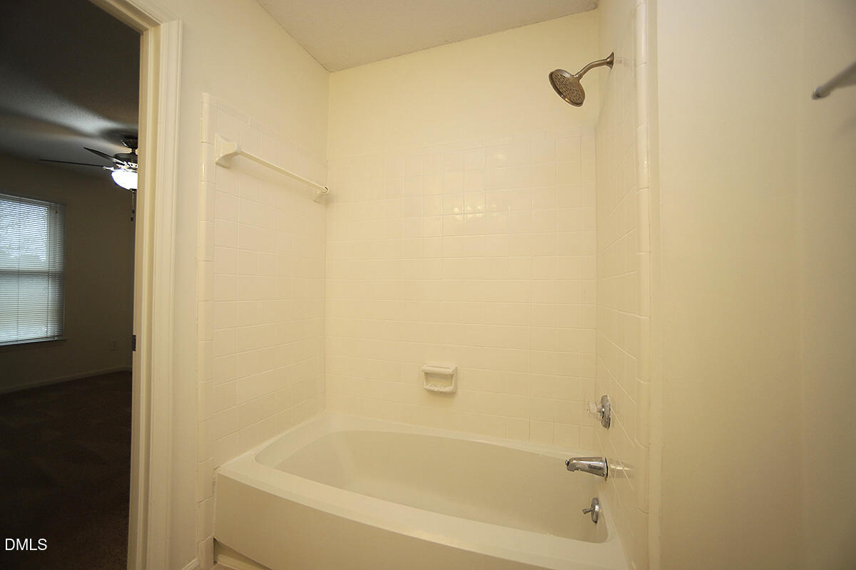 6514 Hearthstone Drive Raleigh, NC 27615 - Photo 13 of 16 a bathroom with a bathtub