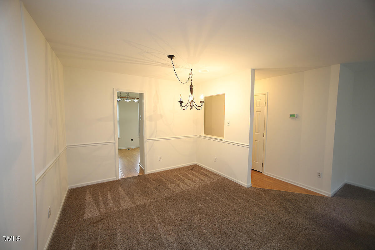 6514 Hearthstone Drive Raleigh, NC 27615 - Photo 5 of 16 a view of empty room with wooden floor