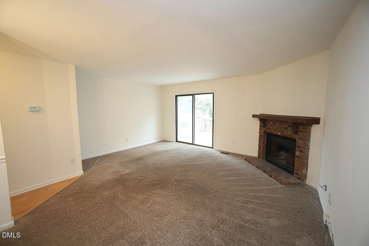 6514 Hearthstone Drive Raleigh, NC 27615 - Photo 7 of 16 a view of empty room with a fireplace