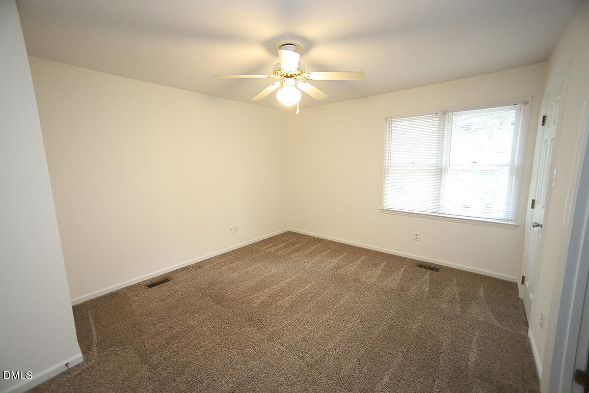 6514 Hearthstone Drive Raleigh, NC 27615 - Photo 9 of 16 an empty room with a window and a fan