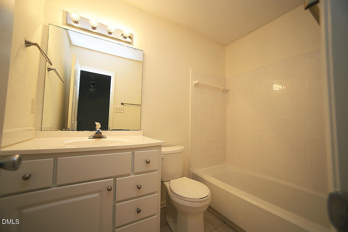 6514 Hearthstone Drive Raleigh, NC 27615 - Photo 10 of 16 a bathroom with a sink a toilet and shower