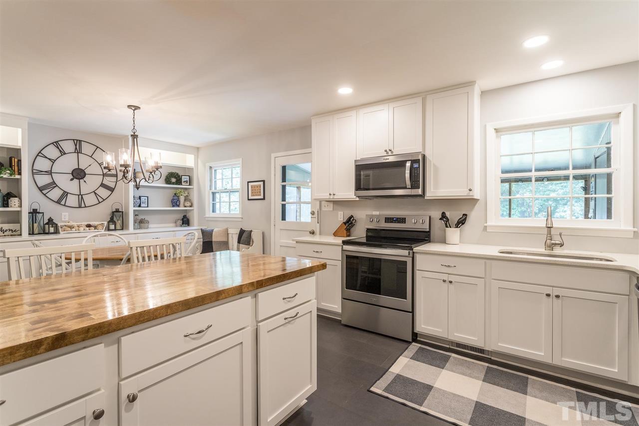 4802 Revere Road Durham, NC 27713 - Photo 22 of 29 a kitchen with a sink stove and microwave