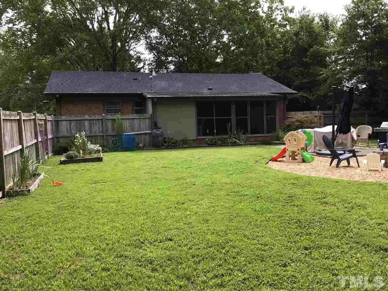 4802 Revere Road Durham, NC 27713 - Photo 4 of 29 a view of a house with a yard and sitting area