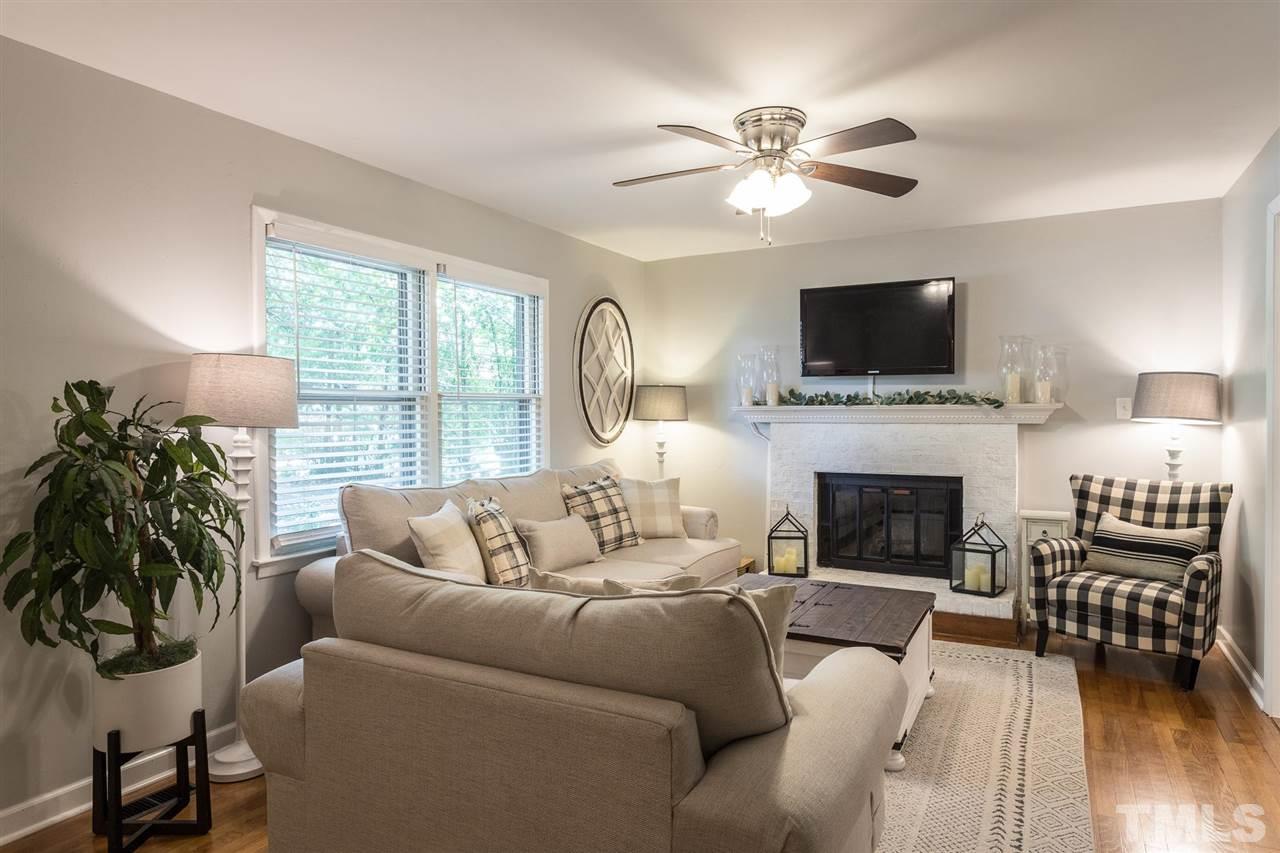 4802 Revere Road Durham, NC 27713 - Photo 8 of 29 a living room with furniture fireplace and a flat screen tv