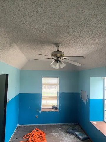 a view of a livingroom with wooden floor and a potted plant