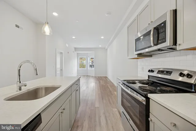 a kitchen that has a sink and a stove
