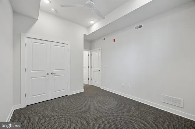 an empty room with closet area