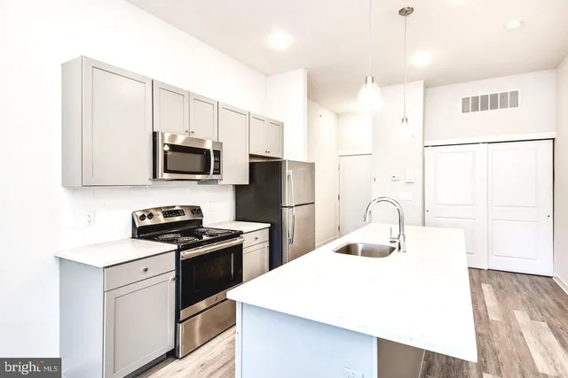 a kitchen with a sink a stove and refrigerator