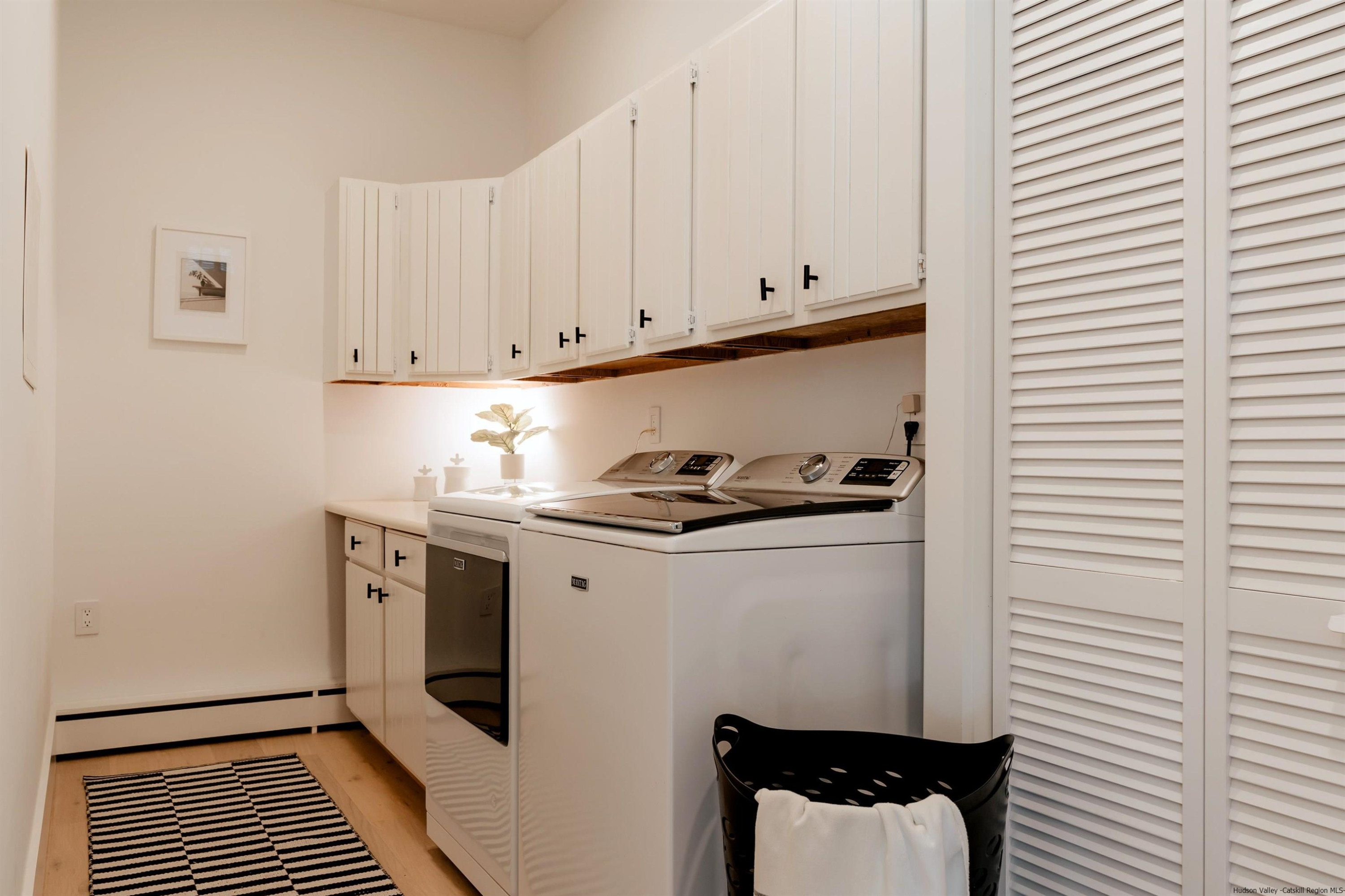 187 Bloom Road Barryville, NY 12719 - Photo 19 of 35 a kitchen with a refrigerator and white cabinets