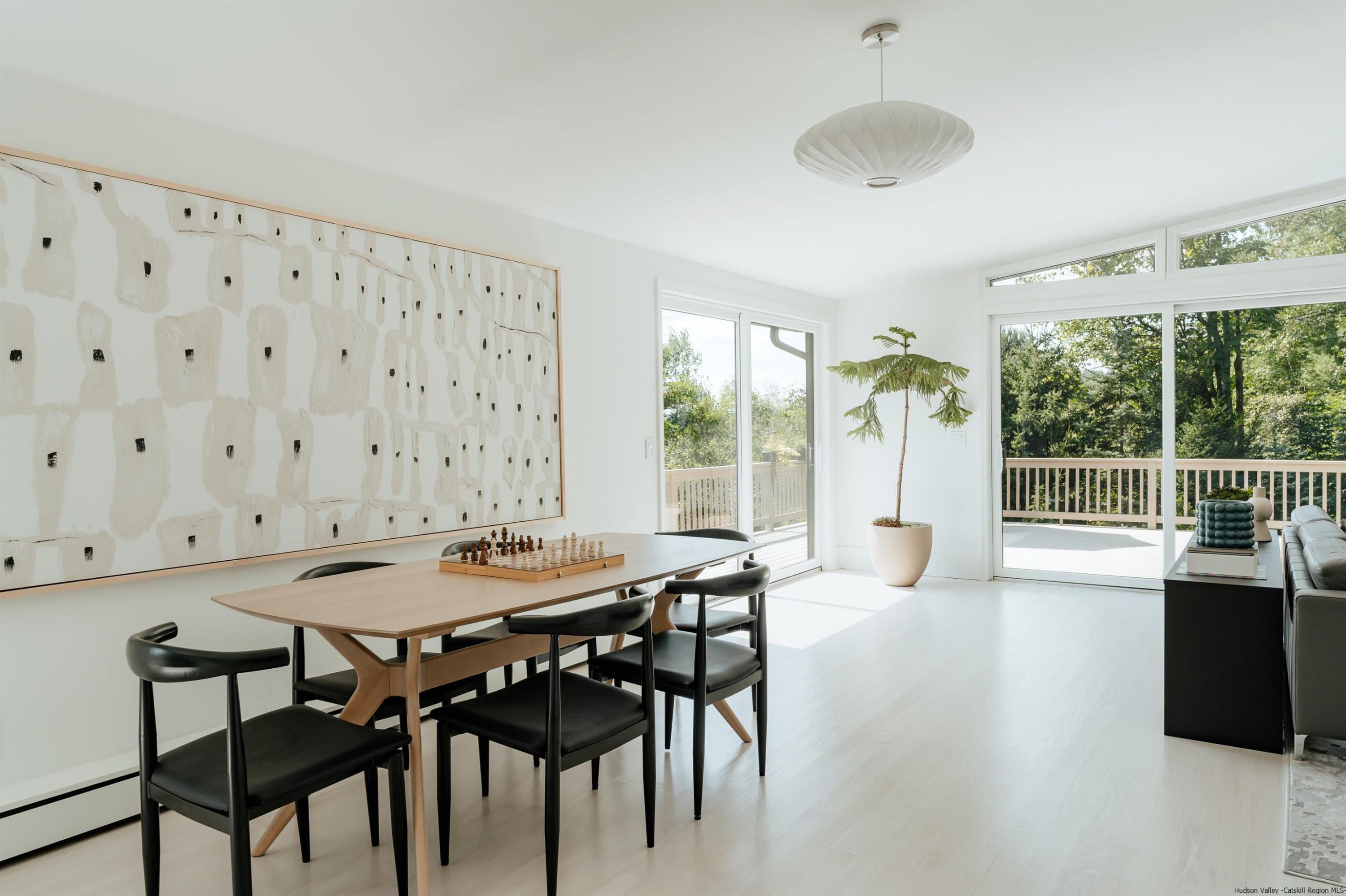 187 Bloom Road Barryville, NY 12719 - Photo 22 of 35 a dining room with furniture and a floor to ceiling window