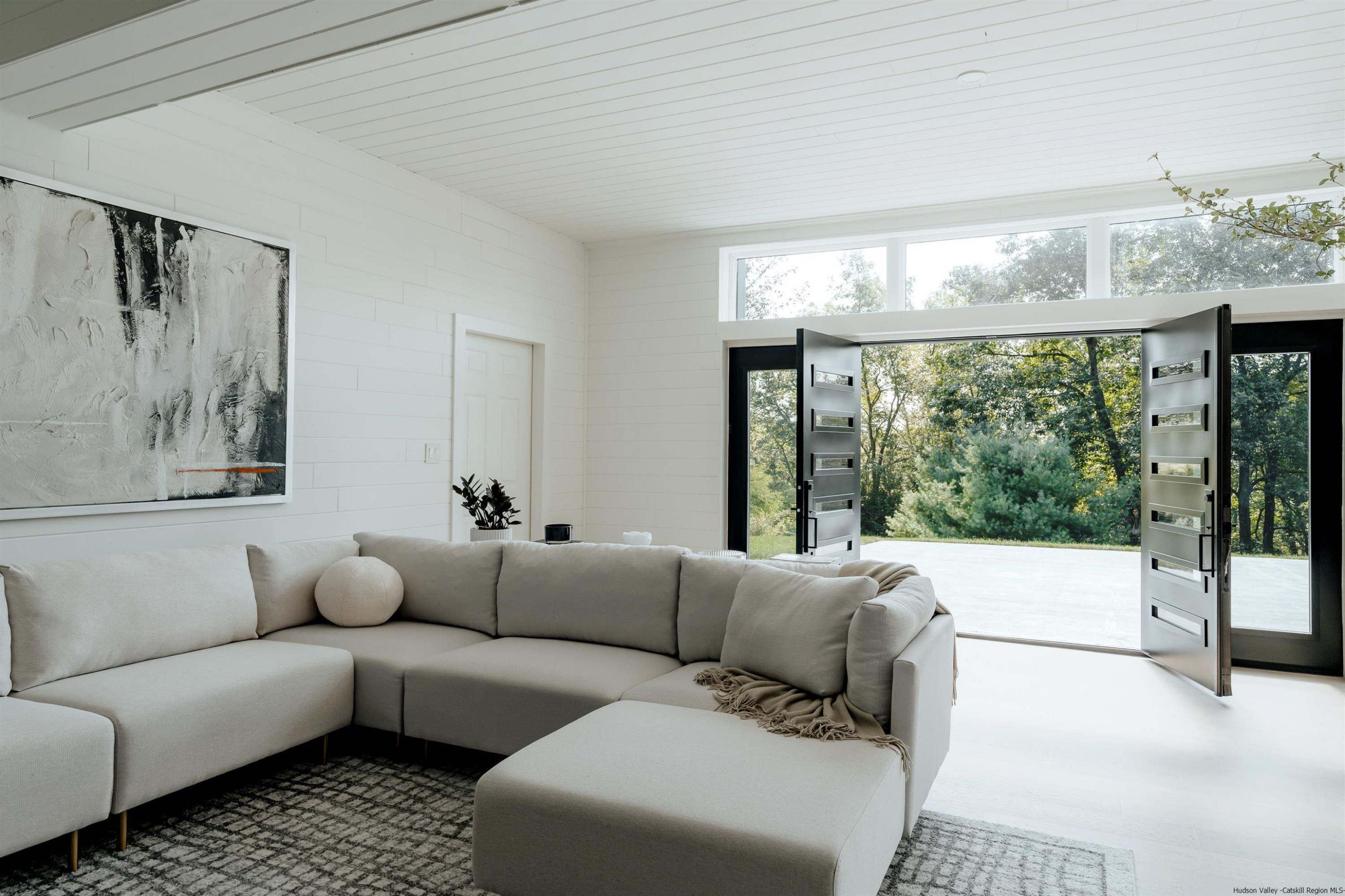 187 Bloom Road Barryville, NY 12719 - Photo 10 of 35 a living room with furniture and a large window