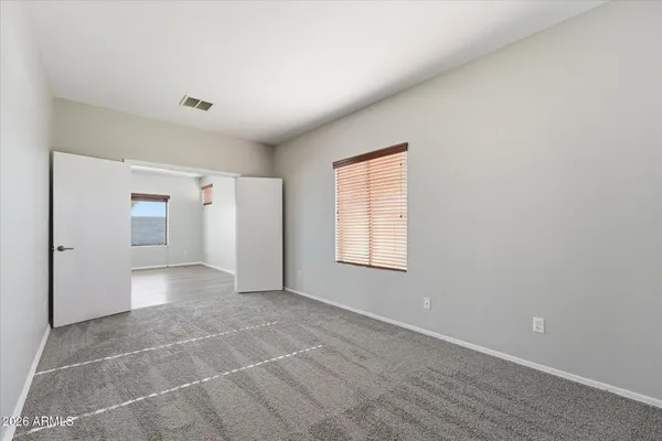 an empty room with a empty space and windows