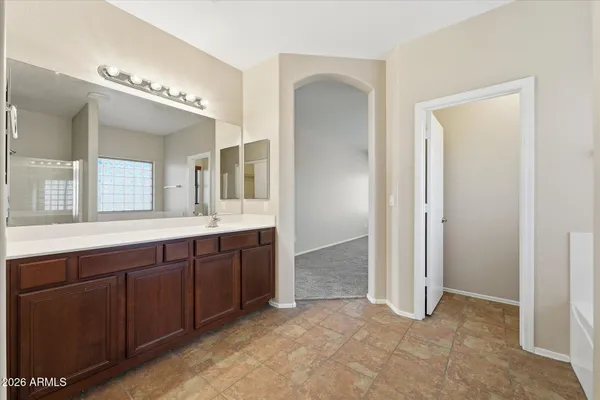 a spacious bathroom with a double vanity sink and a mirror