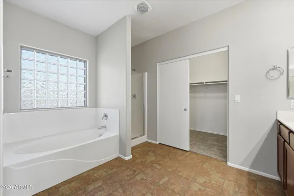 a bathroom with a bathtub and a shower
