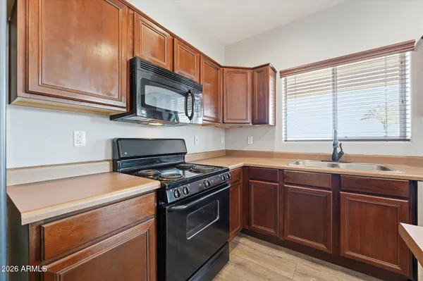 a kitchen with stainless steel appliances a stove sink and cabinets