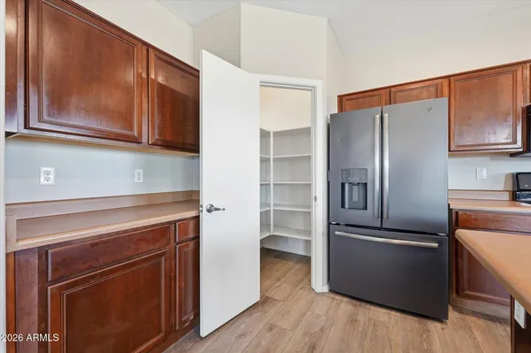 a kitchen with granite countertop stainless steel appliances and wooden cabinets