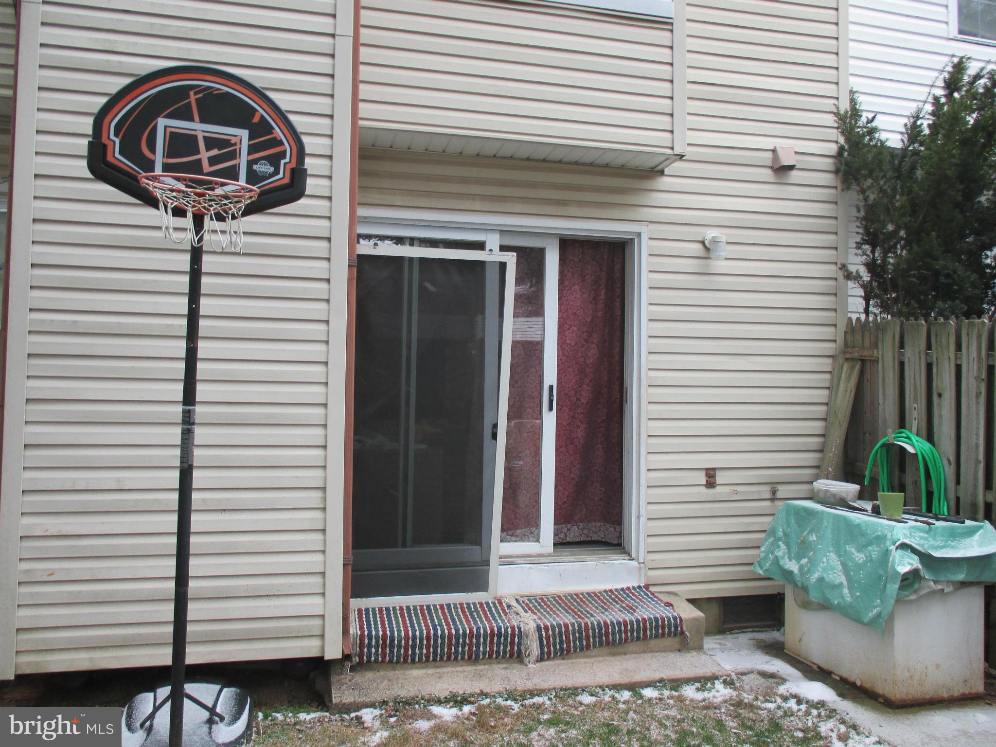 17428 Hoskinson Road Poolesville, MD 20837 - Photo 11 of 12 a view of a house with a door and a tree