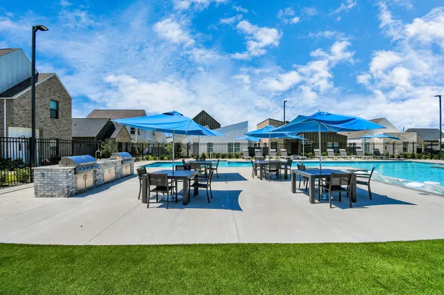 a swimming pool with outdoor seating and yard